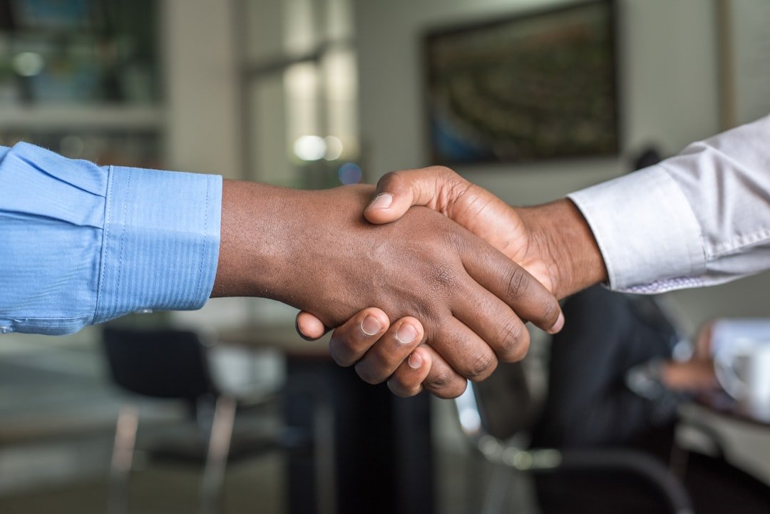 Business partners shaking hands after choosing between private-label and reseller SMM panel model