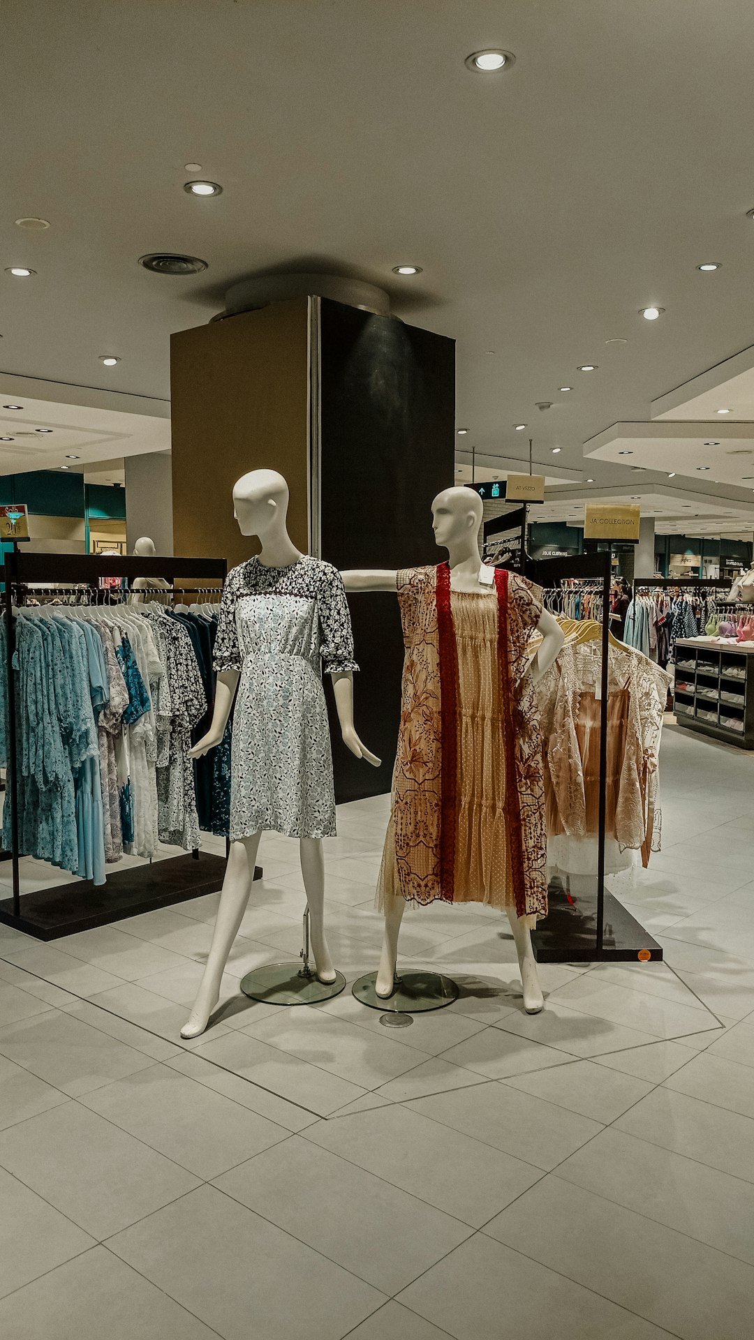 Clothing store display with mannequins and racks of fashion items