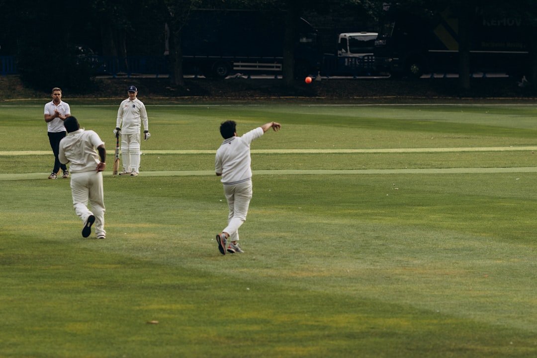 Cricketers on a field during a match, illustrating real-time reaction content during cricket season