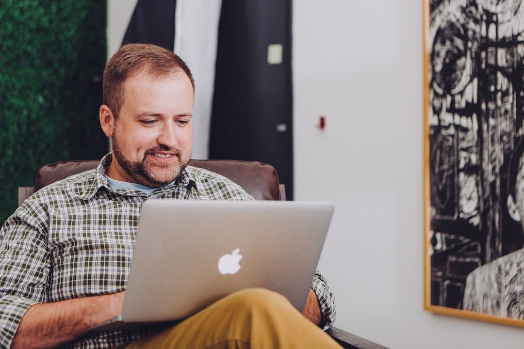 Freelancer smiling while working on a laptop remotely