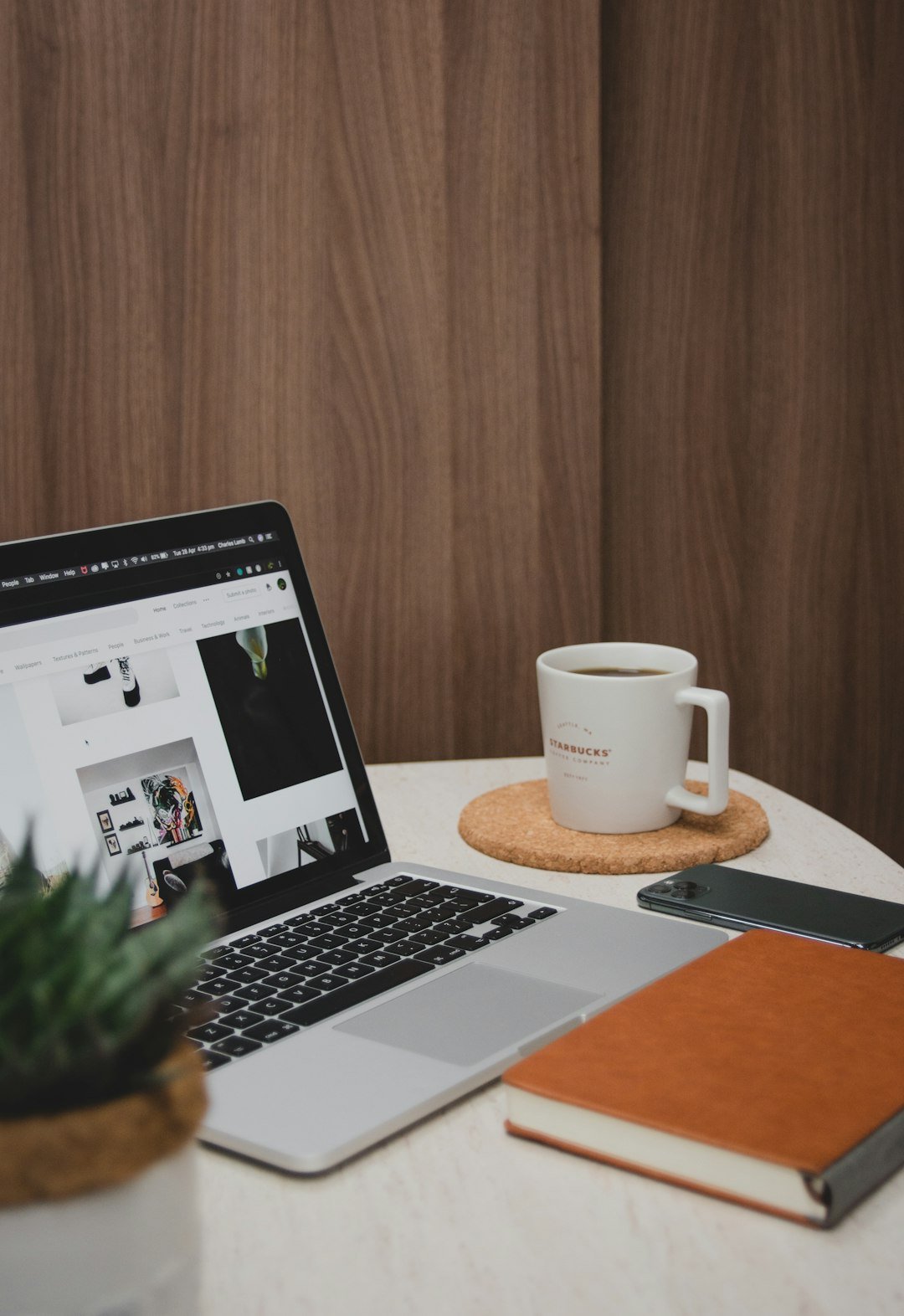 Laptop beside a ceramic mug on a wooden table, set up for blog writing