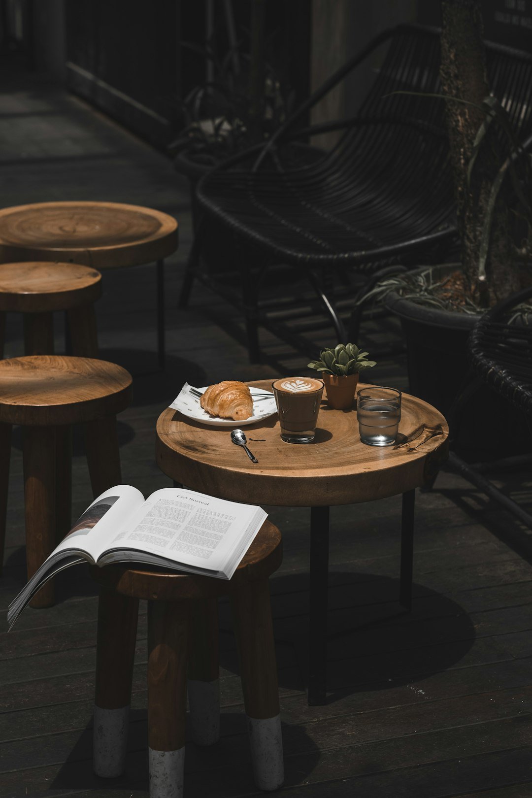 Latte, croissant and book on a cozy cafe table