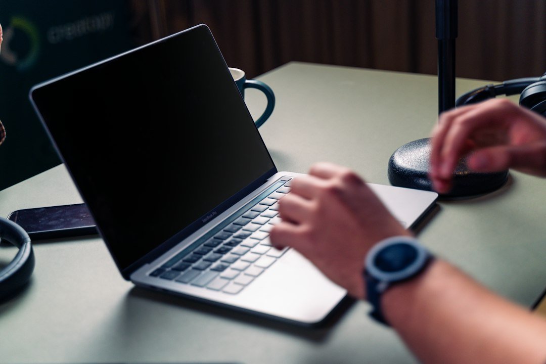 Person browsing and writing content online using a laptop