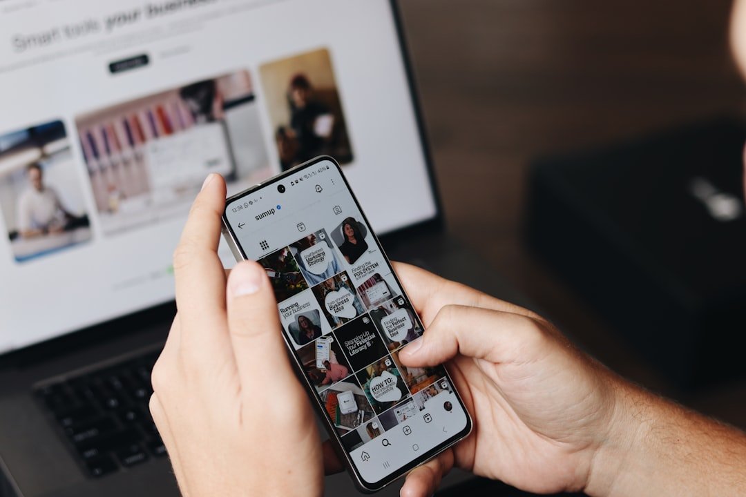Person reviewing phone and laptop content, illustrating pairing influencer content with SMM panel boosts