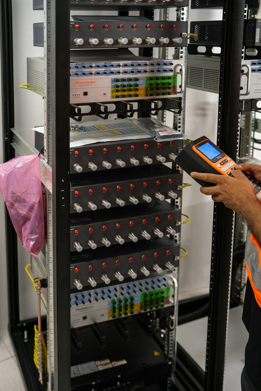 Technician working on a server rack to maintain platform reliability