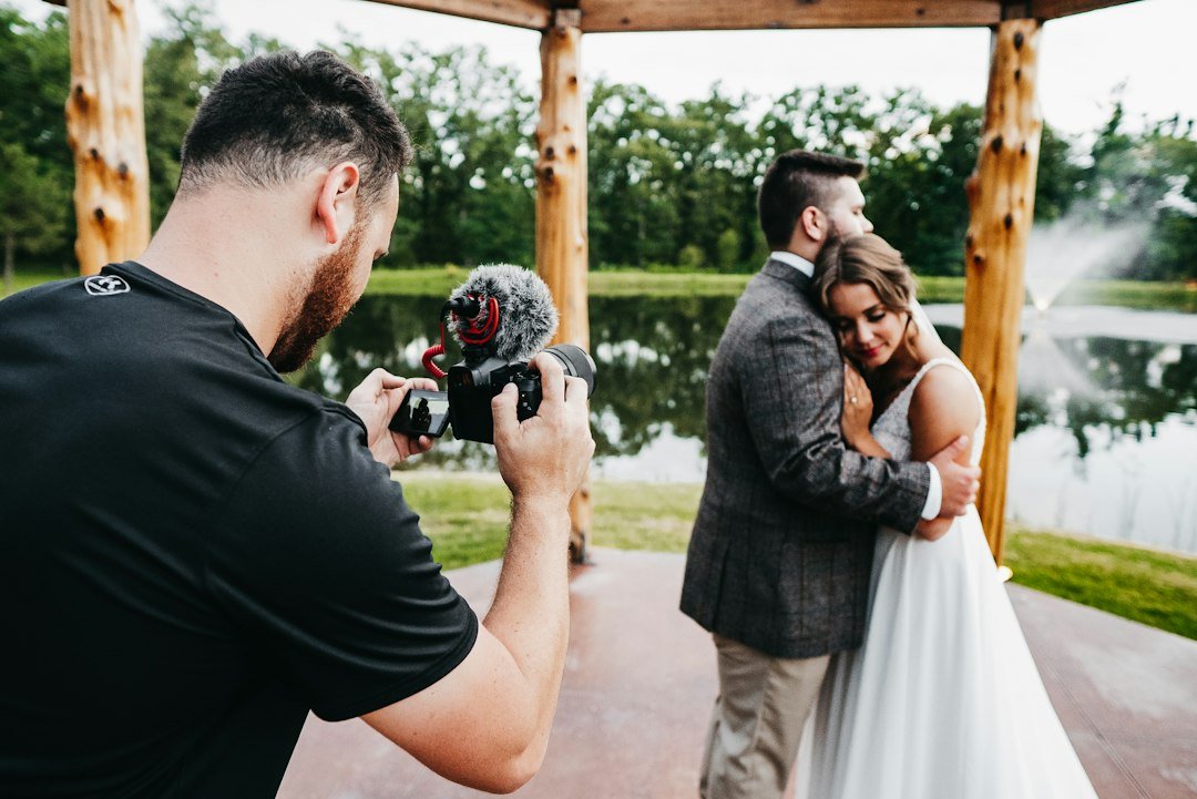 Wedding photographer holding a DSLR camera on the job