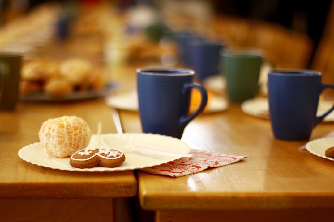 Wooden table topped with plates of food and cups of coffee at a restaurant